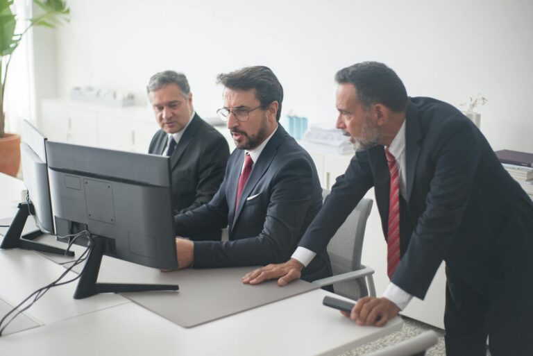 Professionals collaborating on a project in a modern office setting.